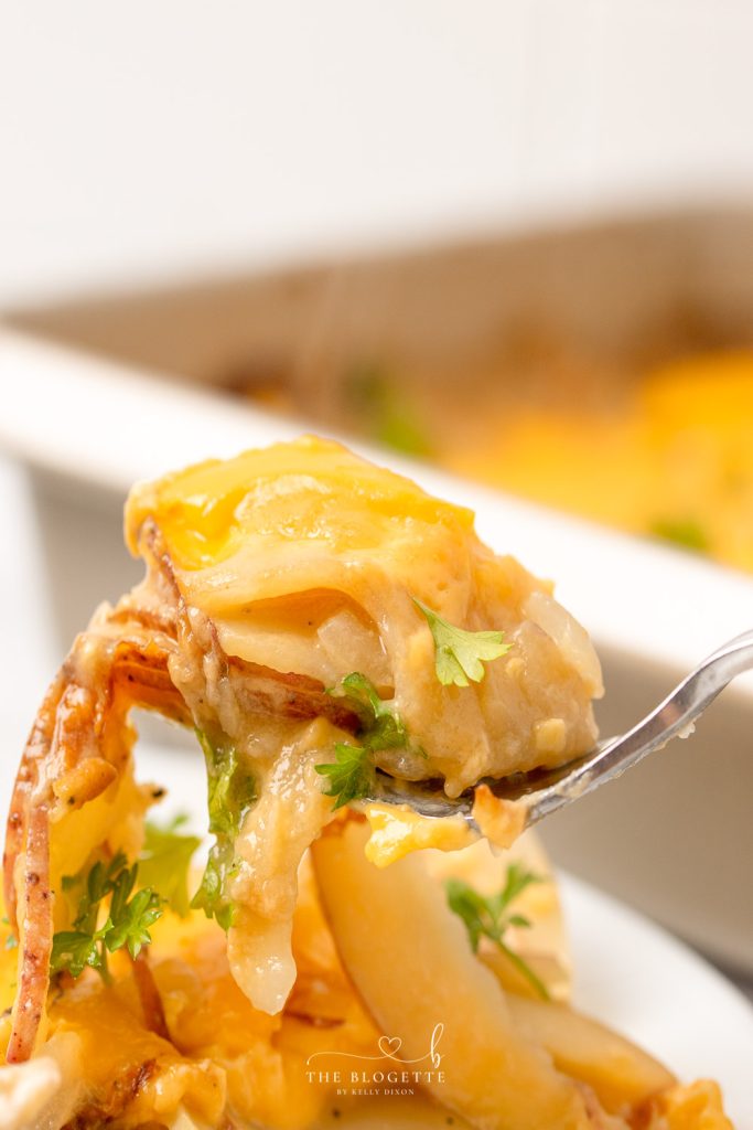 Potatoes Au Gratin are a dinnertime staple around here! Tender potato slices smothered in an addicting cheesy sauce. Au gratin is the ultimate comfort food.