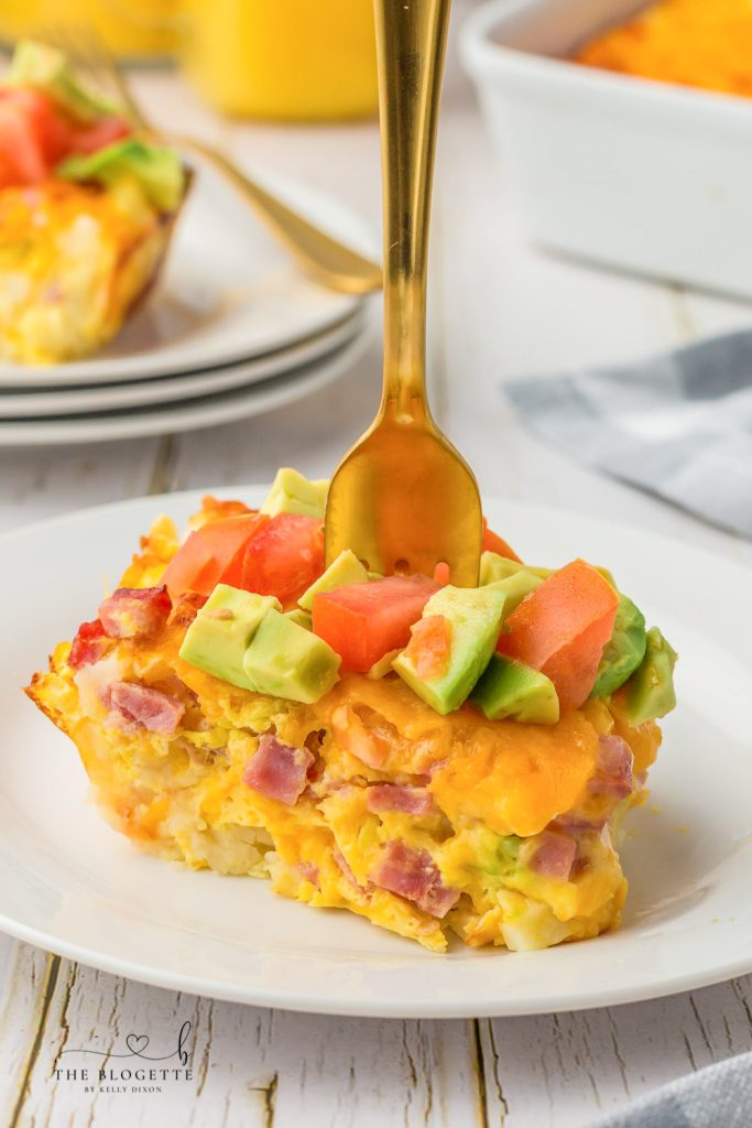 California Breakfast Casserole is loaded with cheese, hash browns, and ham. Topped with delicious avocados and tomatoes.