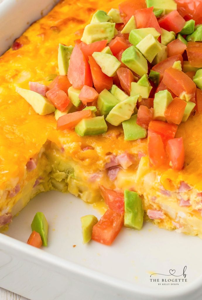 California Breakfast Casserole is loaded with cheese, hash browns, and ham. Topped with delicious avocados and tomatoes.