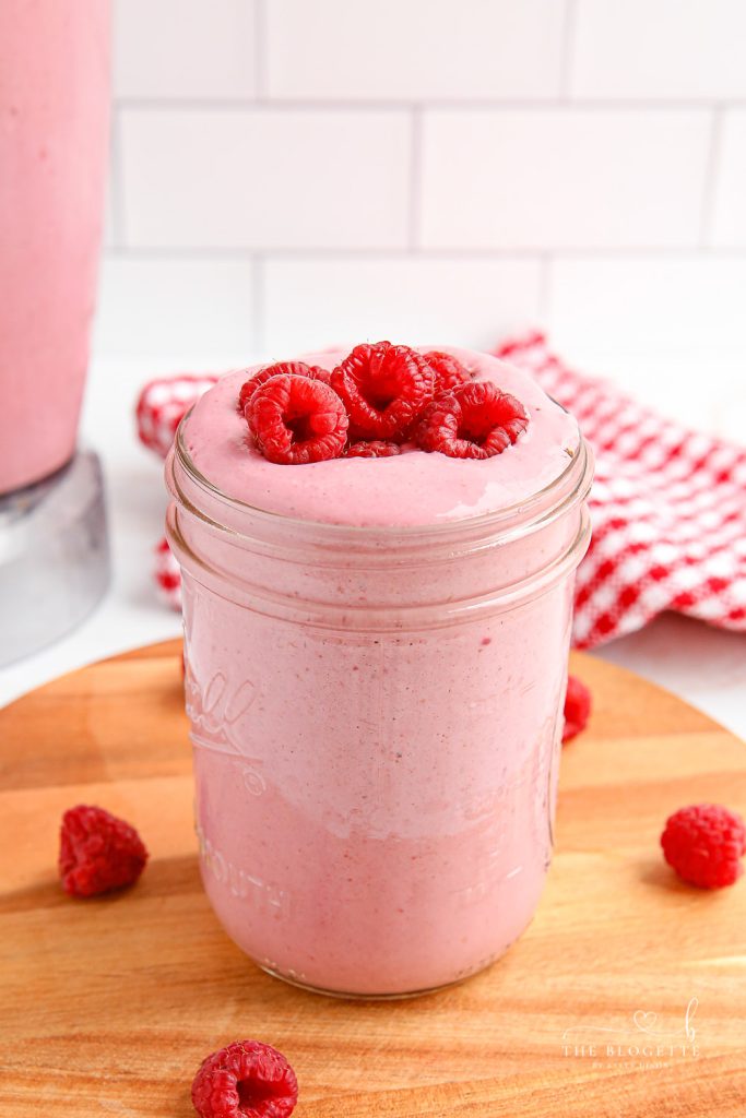 Ultra-smooth and creamy Raspberry Smoothie recipe! While it tastes like ice cream, this smoothie is a healthy way to sneak fruit and grains into your day!