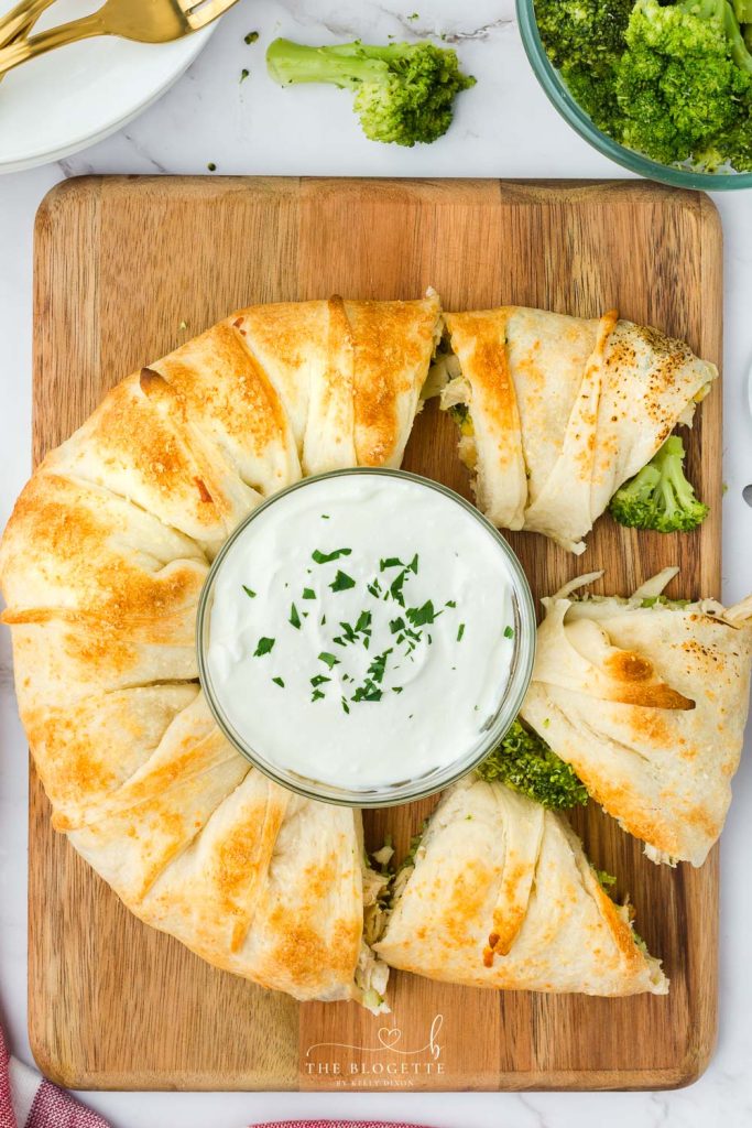 This delicious Cheesy Chicken and Broccoli Ring recipe looks impressive, tastes amazing, and uses up leftover chicken! It's easy to make and is so versatile that it can be an appetizer, a lunch, or a dinner.