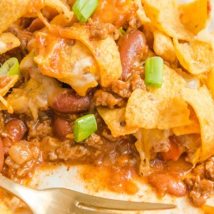 Frito Pie is a casserole made with ingredients like ground beef, taco seasoning, cheese, & Fritos. This can also make Walking Tacos!