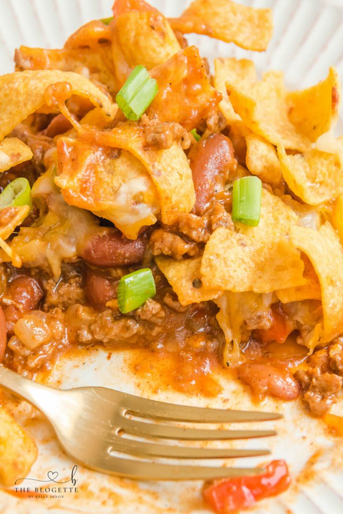 Frito Pie is a casserole made with ingredients like ground beef, taco seasoning, cheese, & Fritos. This can also make Walking Tacos!
