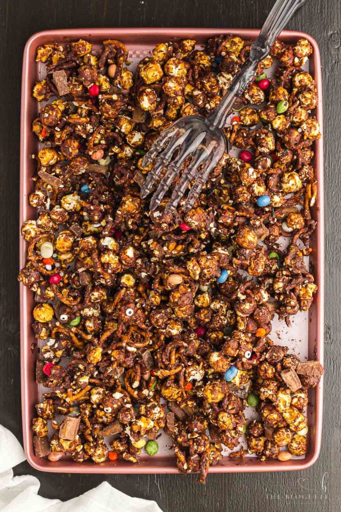 Halloween Snack Mix is chocolate caramel popcorn combined with tasty Halloween treats and salty pretzels. A Halloween party treat!