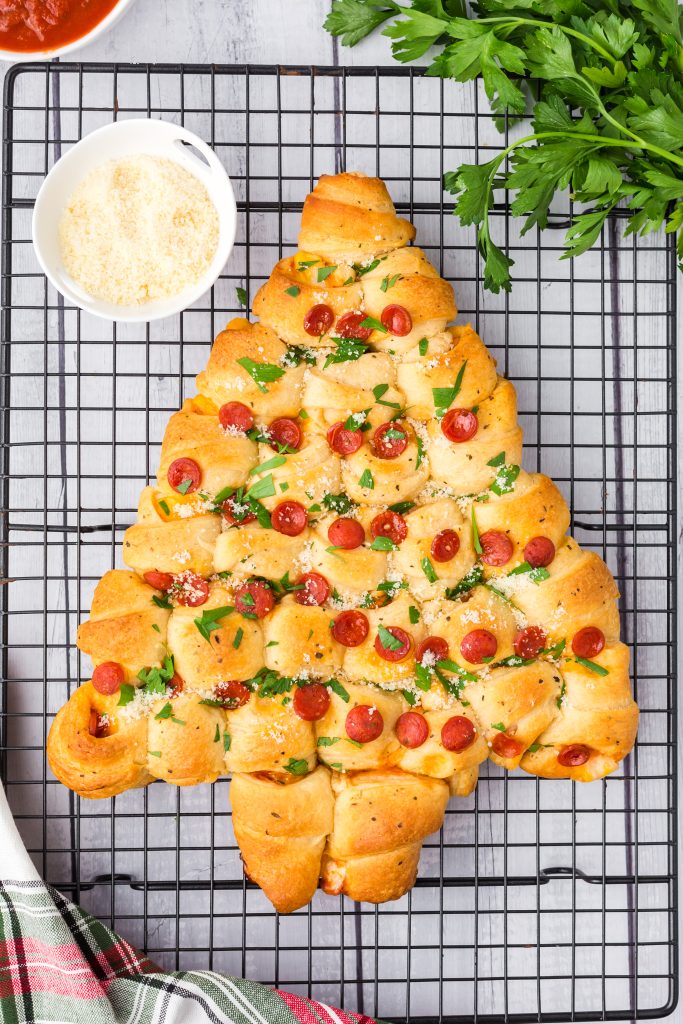 A pepperoni and cheese Christmas Tree Pull Apart Bread is the perfect Christmas appetizer! Easy, versatile, and makes everyone smile!