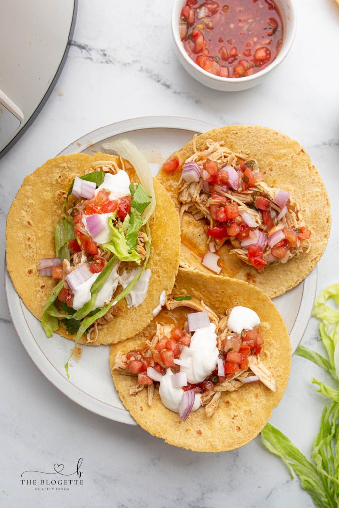 Crock Pot Ranch Chicken Tacos are so flavorful, tender, and tasty! This slow-cooker chicken is perfect for tacos, tostadas, enchiladas, salads, and burritos!