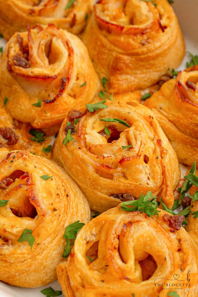 Baked Turkey and Cheese Rolls have melted cheese, bacon, and turkey covered in a garlic buttery glaze! The perfect party appetizer idea!
