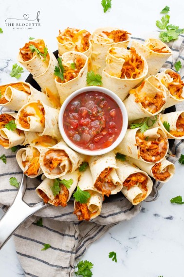 A Blooming Burrito Ring is the perfect appetizer for any occasion! A round display of chicken and bean burritos served with a bowl of dip.