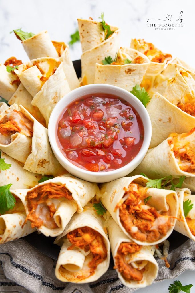 A Blooming Burrito Ring is the perfect appetizer for any occasion! A round display of chicken and bean burritos served with a bowl of dip.