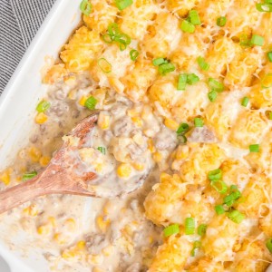 Cowboy Casserole is an easy and comfort-food dinner with simple ingredients like ground beef, corn, cheese, and sour cream, then topped with delicious tater tots.