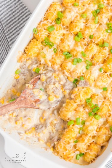Cowboy Casserole is an easy and comfort-food dinner with simple ingredients like ground beef, corn, cheese, and sour cream, then topped with delicious tater tots.