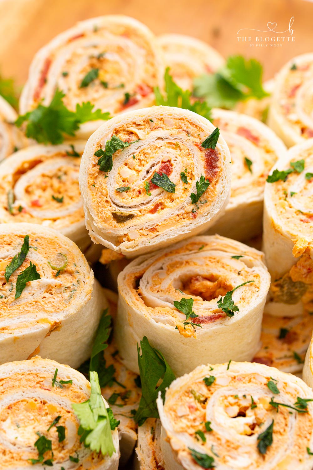 Chicken Enchilada Roll Ups are the perfect appetizer or snack for any party or occasion. This make-ahead appetizer is made with easy-to-find ingredients like taco seasoning, cream cheese, and shredded chicken (or leftover chicken!).