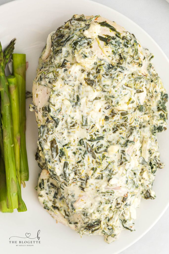 Spinach Dip Chicken Bake - Baked to perfection in 45 minutes! Creamy spinach cheese sauce smothered onto juicy chicken breasts. 