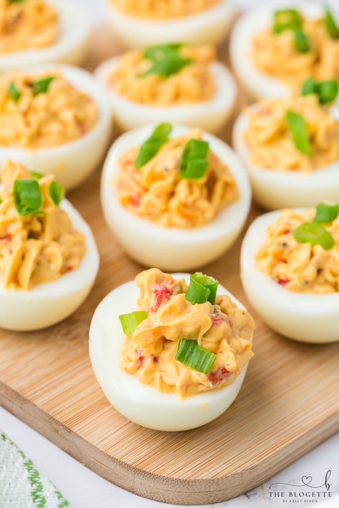 Bacon Pimento Deviled Eggs Recipe - Delicately displayed egg whites filled with a creamy pimento cheese mixture and topped with bacon!