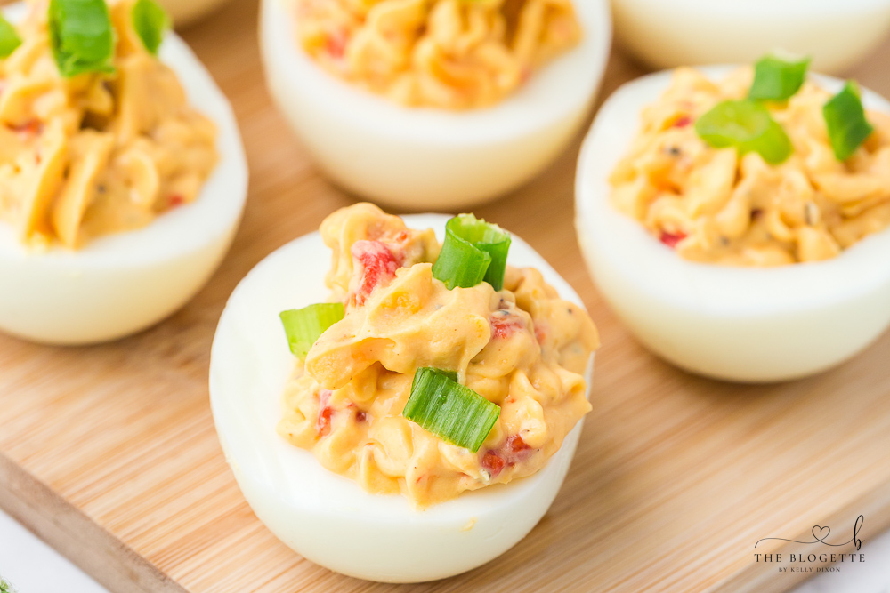 Bacon Pimento Deviled Eggs Recipe - Delicately displayed egg whites filled with a creamy pimento cheese mixture and topped with bacon!