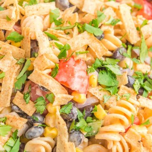 Creamy Ranch Taco Pasta Salad - Ranch dressing and taco seasoning folded into pasta with tomatoes, beans, corn, and more!