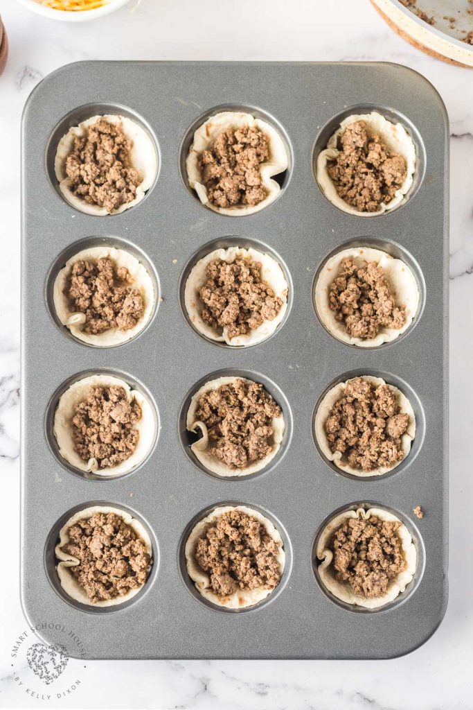 Flour tortillas stuffed with ground beef in a muffin tin