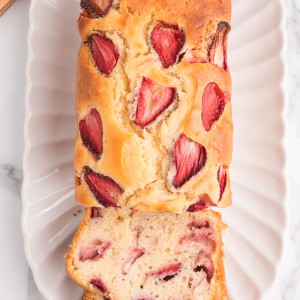 Sweet and soft Strawberry Bread is a spring and summer staple treat! Made with fresh strawberries, this quick bread recipe is the perfect way to enjoy strawberries while they're in season.
