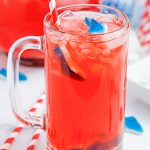 Shark Attack Punch or mocktail is the ultimate summertime drink! Tasty red punch served with floating shark gummies. Shark Punch is perfect for Shark Week or beach-themed parties!