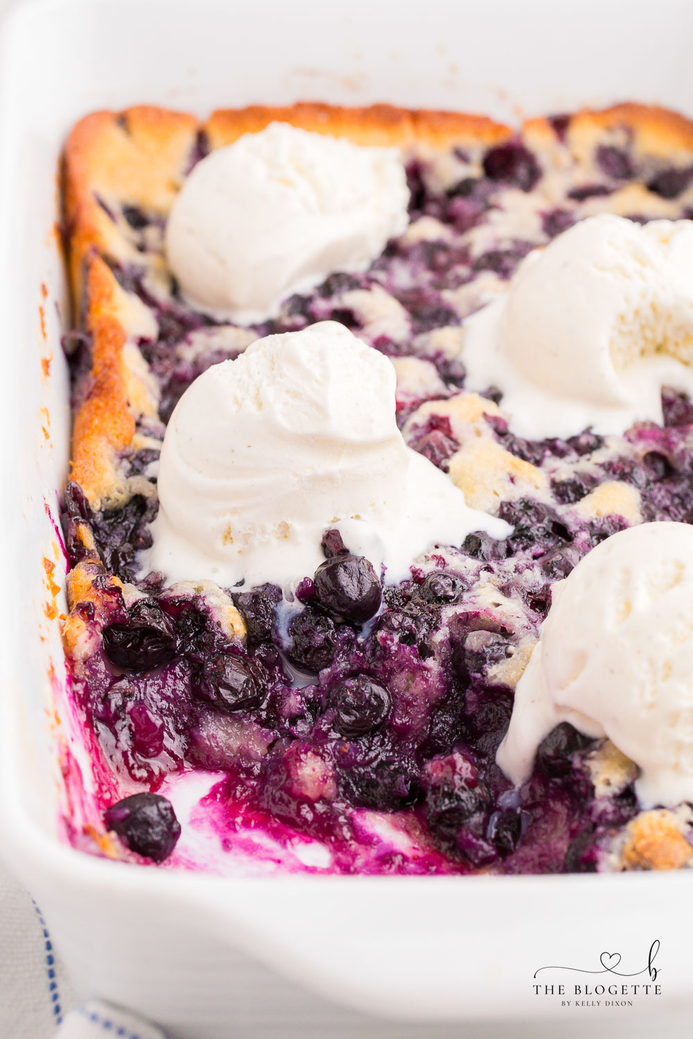 Blueberry Cobbler is a delicious and easy recipe to use with all of those summer blueberries! It's a quick and easy dessert topped with a scoop of vanilla ice cream. 