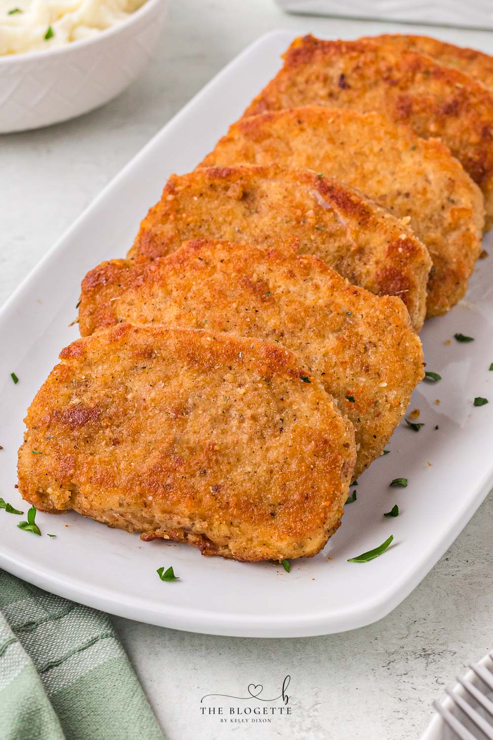 Breaded Fried Pork Chops cooked to crispy perfection! Golden brown boneless pork chops are crispy on the outside and juicy on the inside.