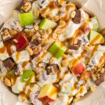 Snickers Apple Salad is a delightful dessert with a combination of apples and Snickers bars in a creamy white chocolate whipped cream sauce.