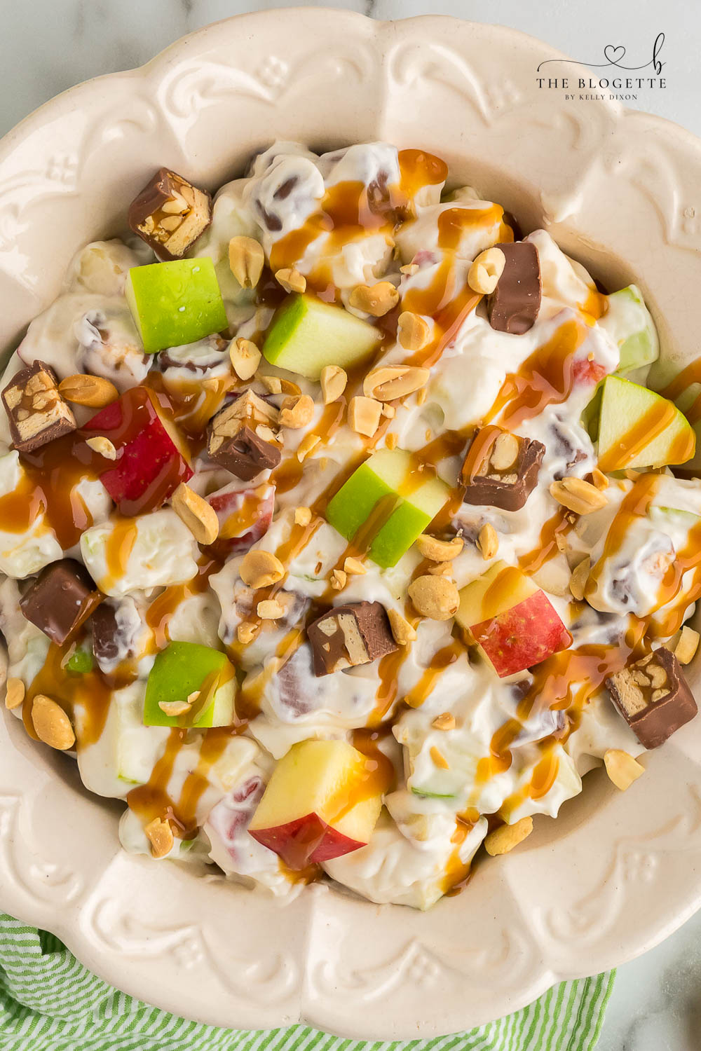 Snickers Apple Salad is a delightful dessert with a combination of apples and Snickers bars in a creamy white chocolate whipped cream sauce.