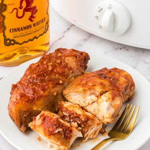 Crock Pot Fireball Chicken - a flavorful slow cooker chicken seasoned with a homemade Fireball-flavored sauce! The whiskey sauce makes the chicken so juicy and delicious.