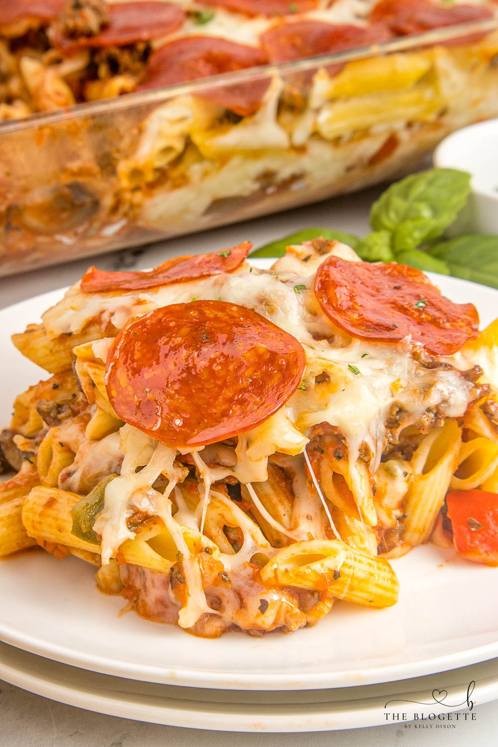 Pizza casserole has layers of pasta, sauce, and ooey-gooey cheese, along with your favorite pizza toppings.