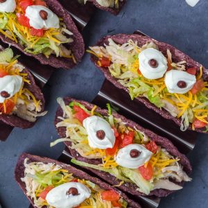 Monster Tacos for Halloween! These crock pot ranch chicken tacos feature blue corn taco shells and spooky sour cream eyes!