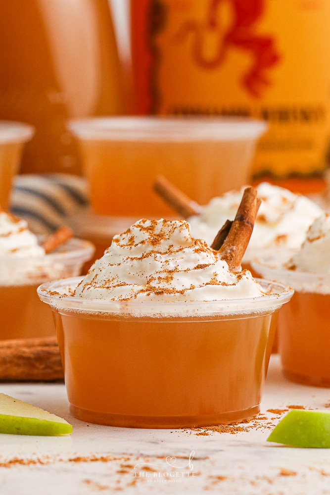 Apple Pie Jello Shots made with Fireball! Topped with whipped cream, this festive jello shot is perfect for the holidays or any fall gathering!