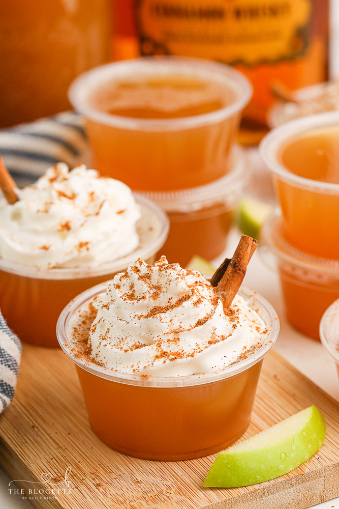 Apple Pie Jello Shots made with Fireball! Topped with whipped cream, this festive jello shot is perfect for the holidays or any fall gathering!