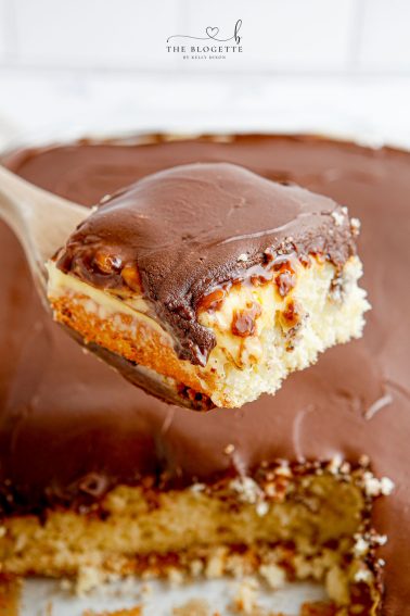 Boston Cream Poke Cake is so simple to whip up. With cake, pudding, and chocolate frosting, this cake is a quick spin on Boston Cream Pie!