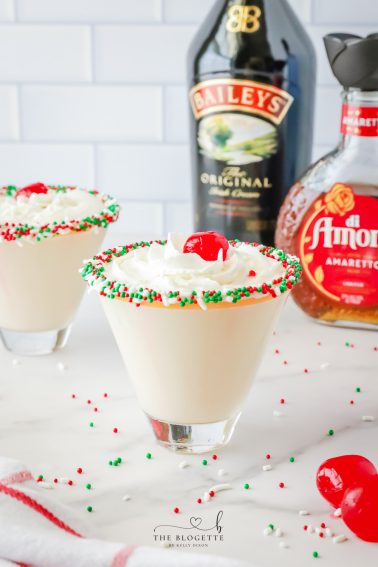 A sugar cookie cocktail for Christmas! Vanilla-rimmed martini glass filled with whipped cream vodka, Irish Cream, and Amaretto.