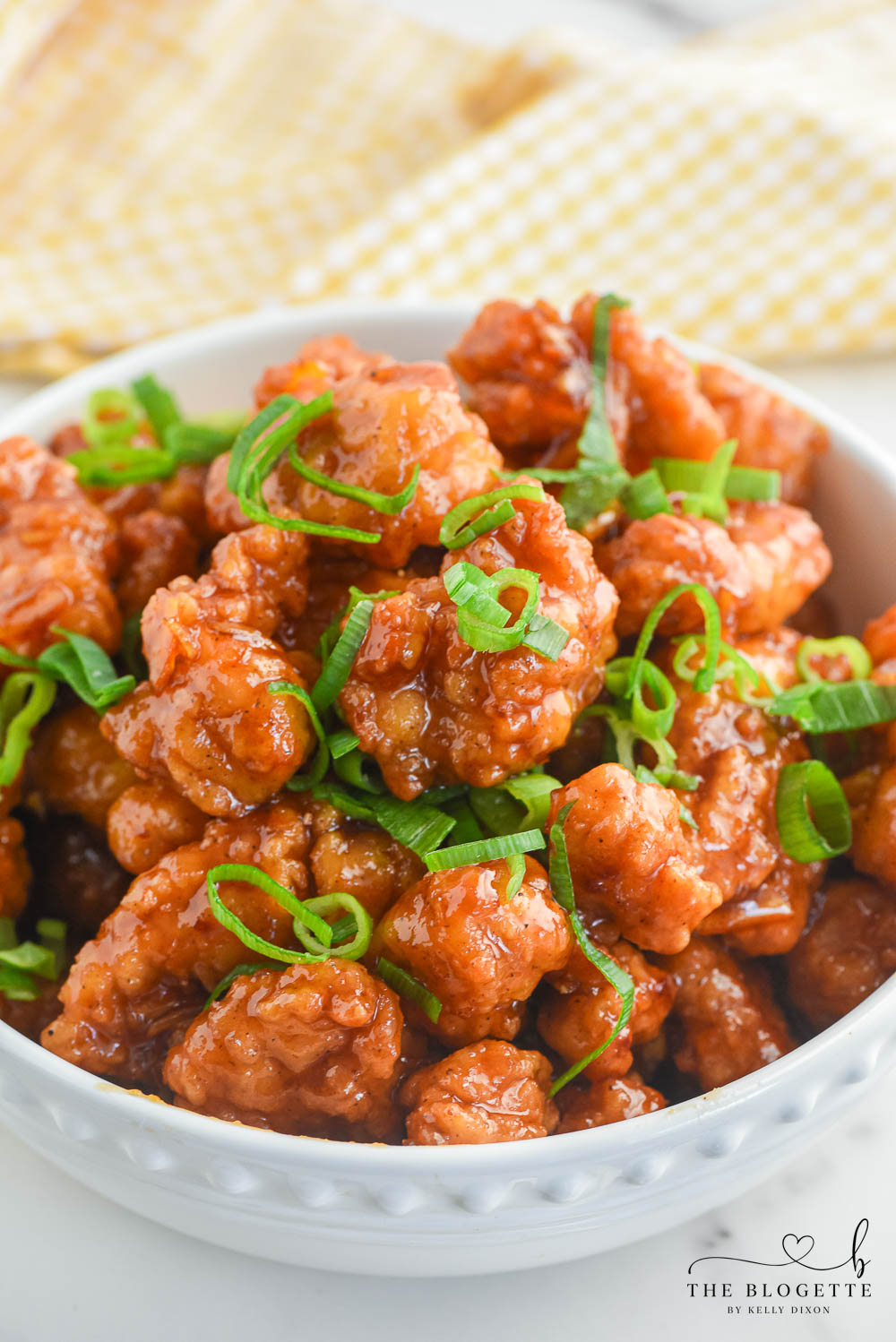 Orange Chicken that's made with 4 ingredients! Yummy bites of chicken covered in a sweet and flavorful orange sauce. 30-minute dinner recipe!