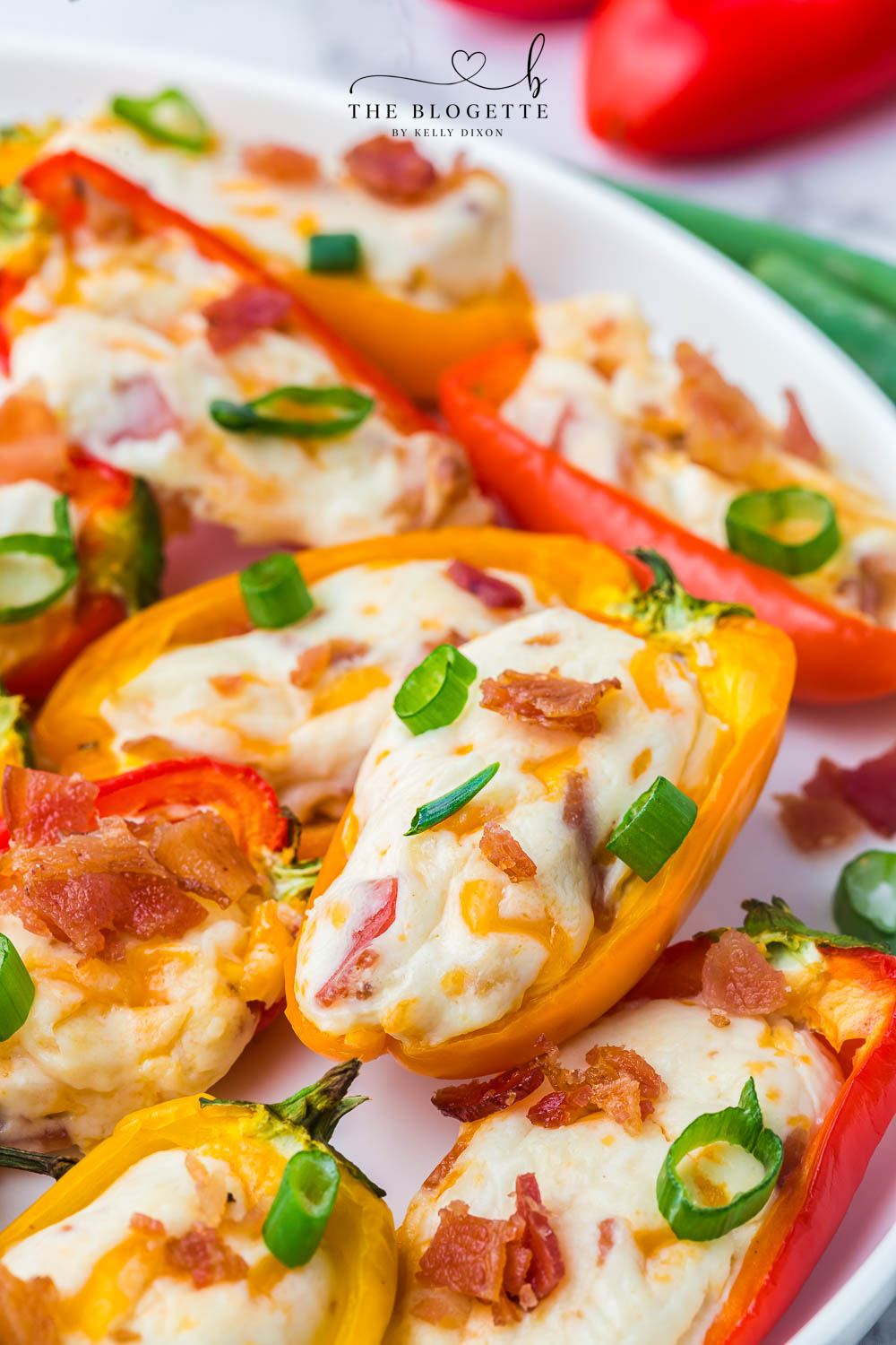 Cheesy Bacon Stuffed Mini Peppers! An easy appetizer idea for any gathering! Sweet mini peppers overflowing with cheese, bacon, and more!
