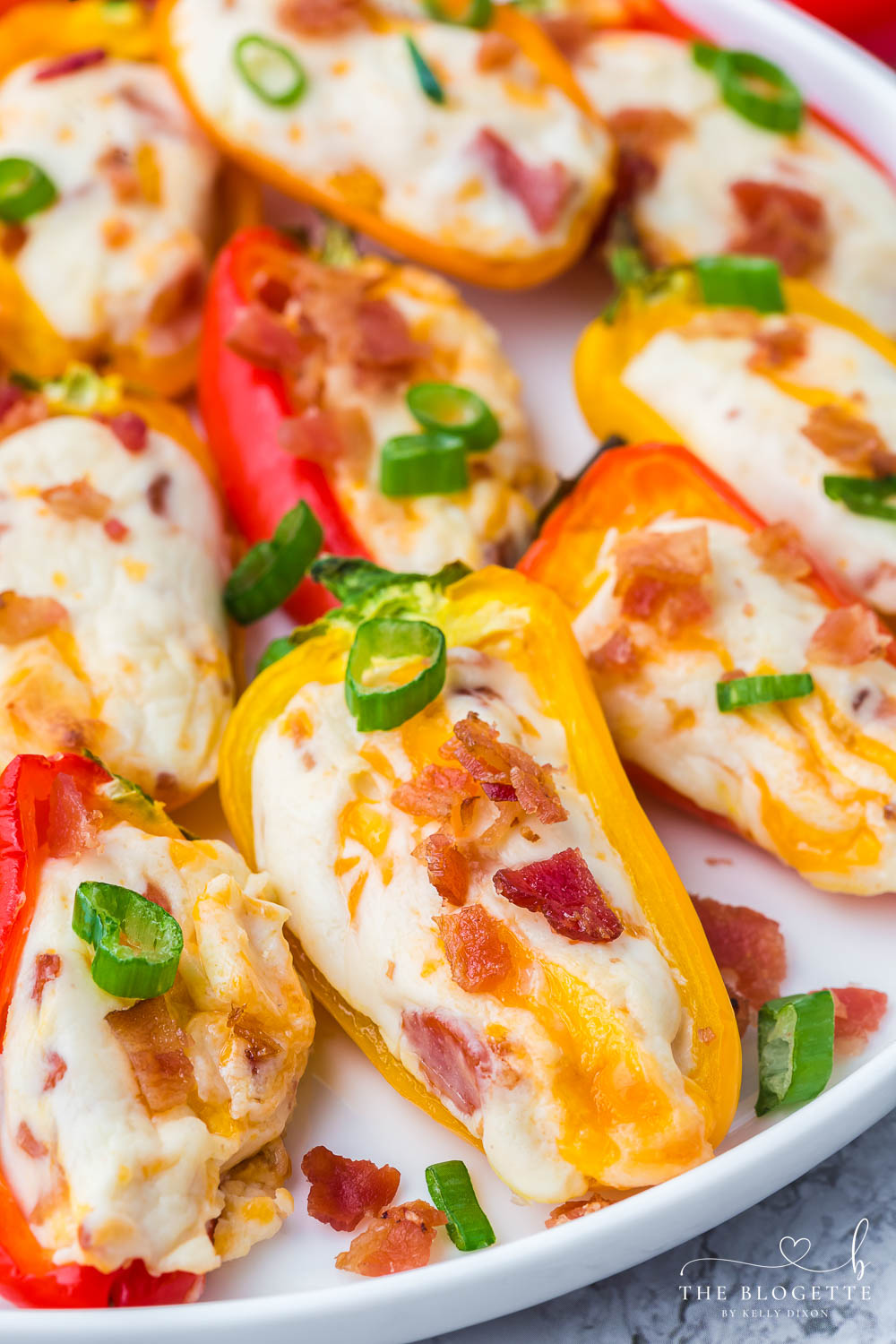 Cheesy Bacon Stuffed Mini Peppers! An easy appetizer idea for any gathering! Sweet mini peppers overflowing with cheese, bacon, and more!