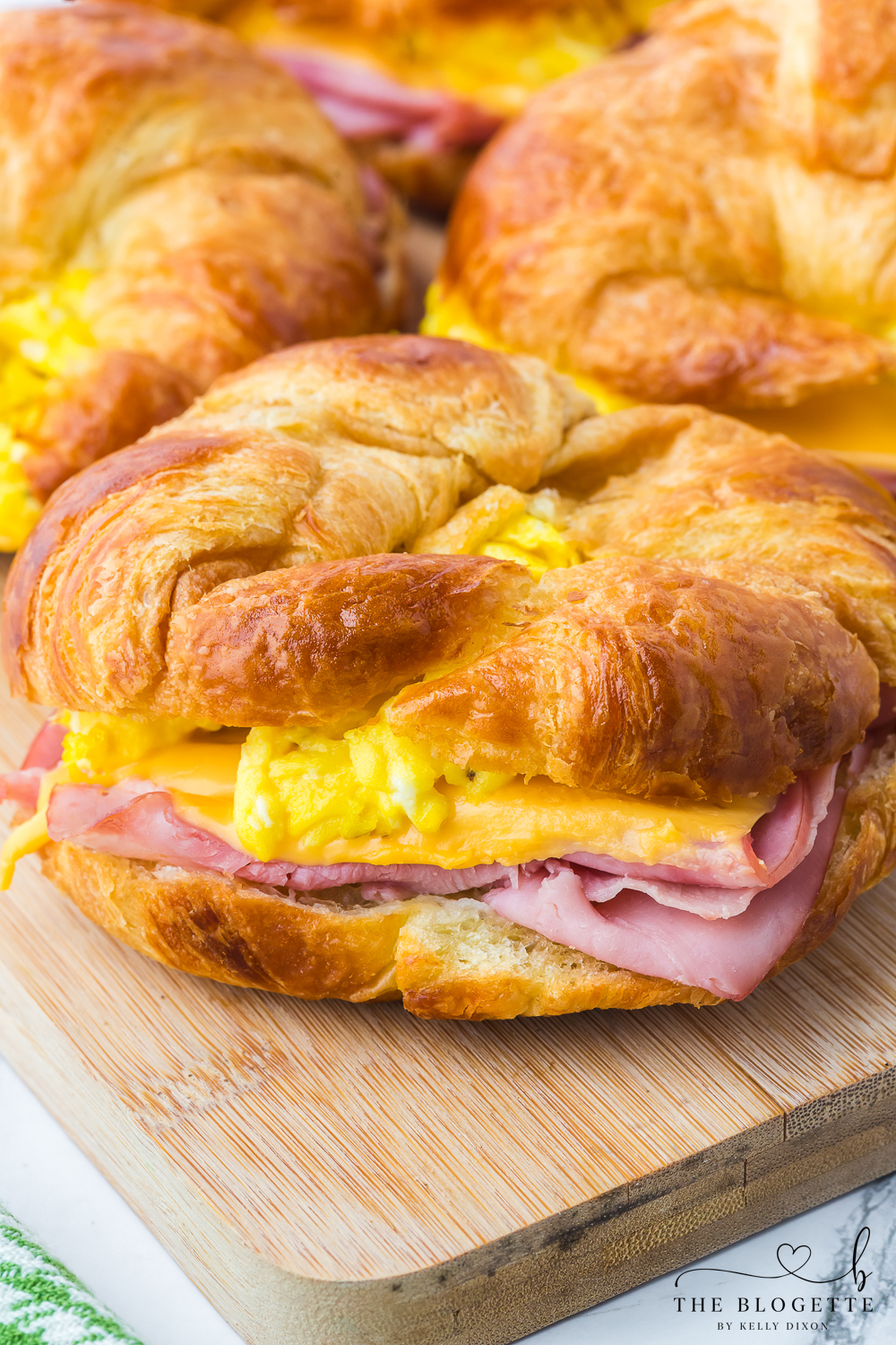 Croissant Breakfast Sandwiches are the ultimate breakfast comfort! Buttery flakey bread stuffed with eggs, ham, and melted cheese.