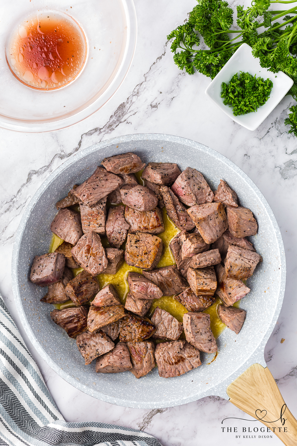 Cooking steak cubes in melted butter and garlic