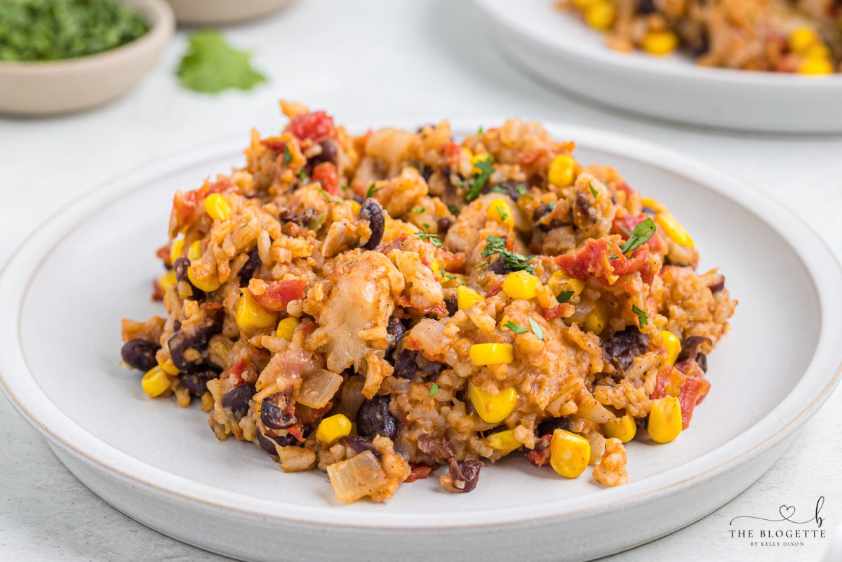 One-pan Tex Mex Chicken and Rice packed with chicken, rice, tomatoes, beans, corn, chilies, and ooey gooey melted cheese!