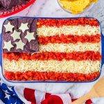 American Flag 7-Layer Dip! One of everyone's favorite 4th of July appetizers! A taco dip filled with beans, guacamole, salsa, and sour cream.