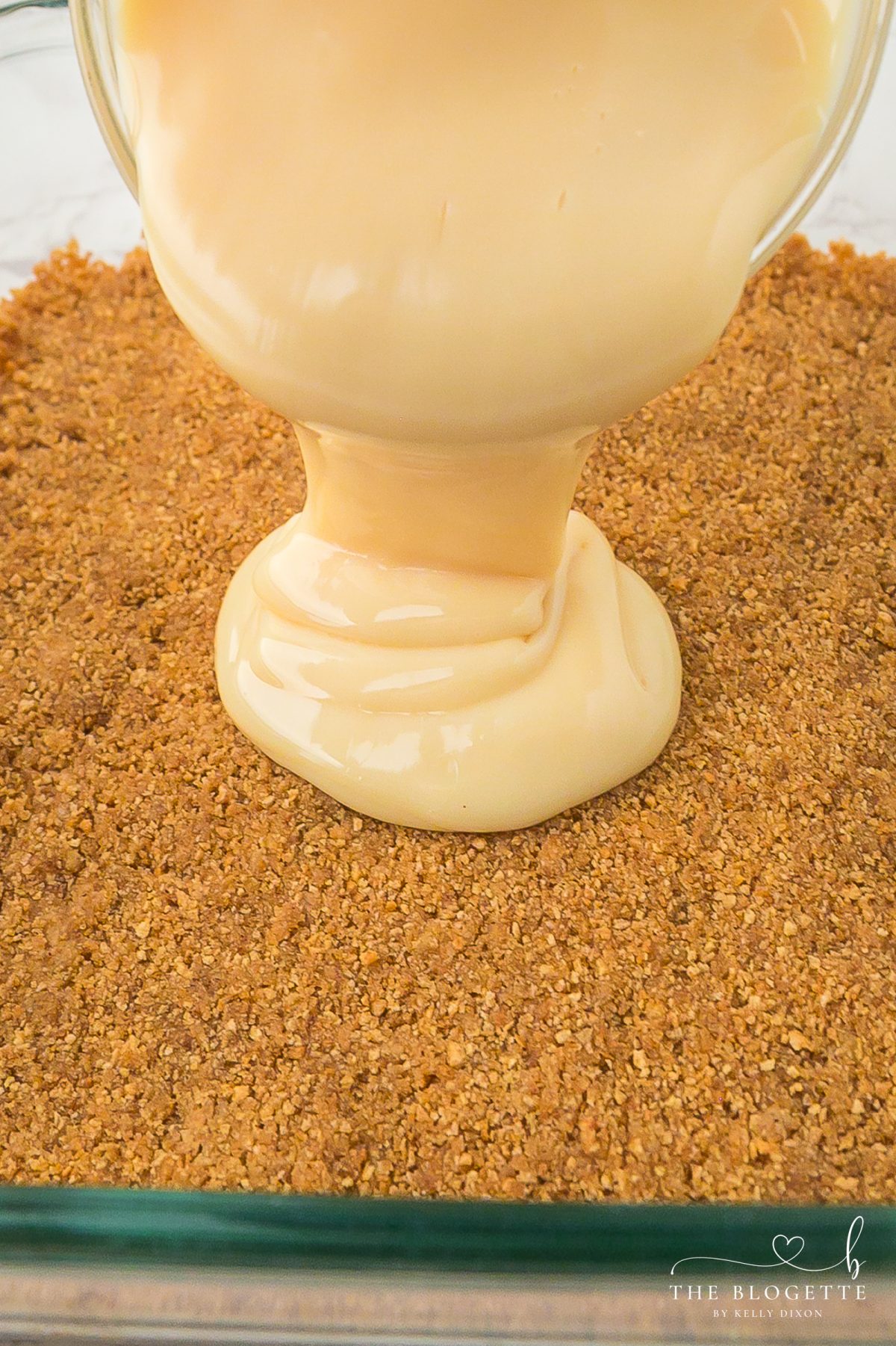 Pour the sweetened condensed milk over the crust