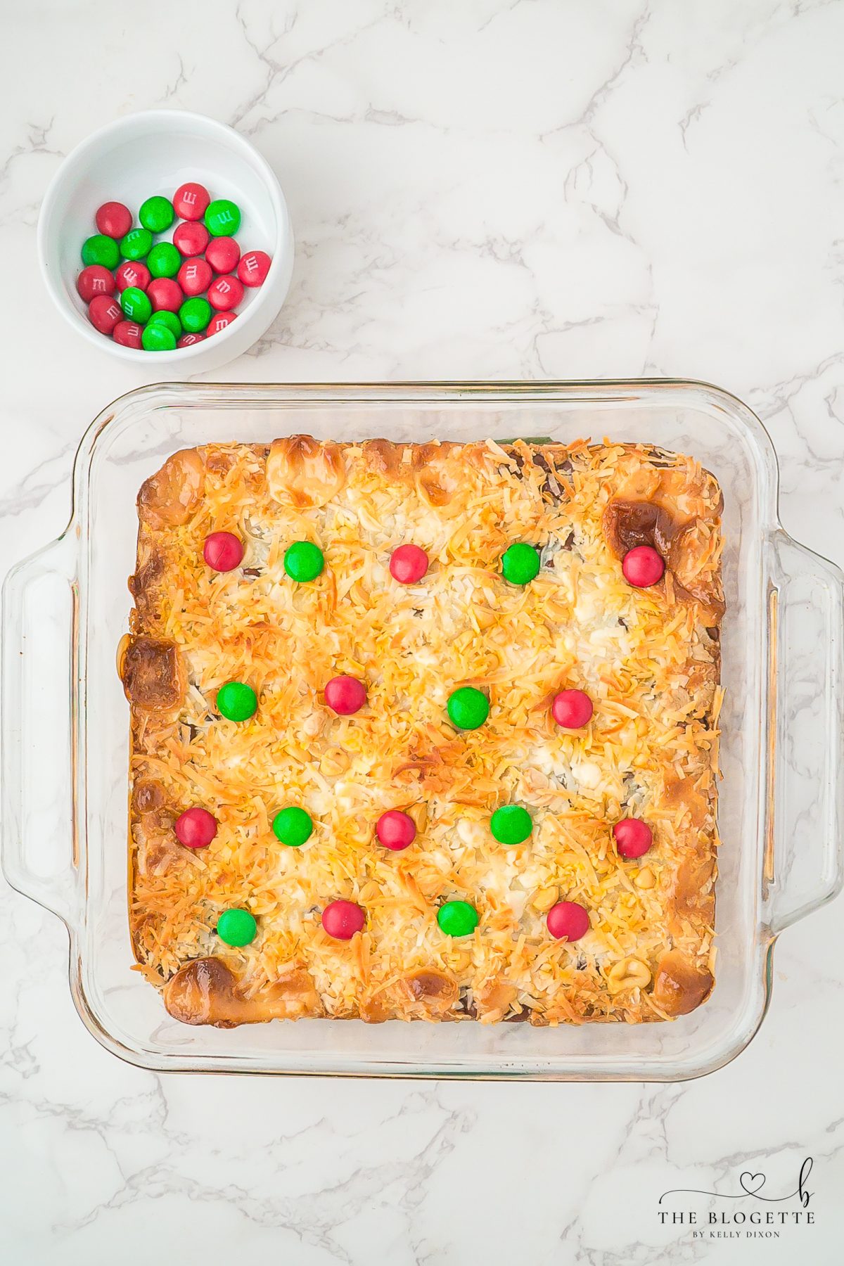 press the holiday colored M&M’s into rows on top of the bars