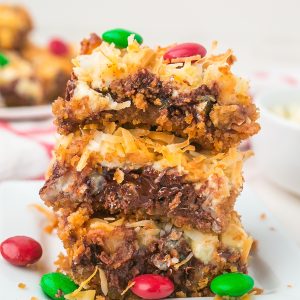 Easy Christmas Magic Bars made with graham crackers, sweetened condensed milk, chocolate chips, coconut, and festive M&M’s. A quick holiday dessert everyone loves!