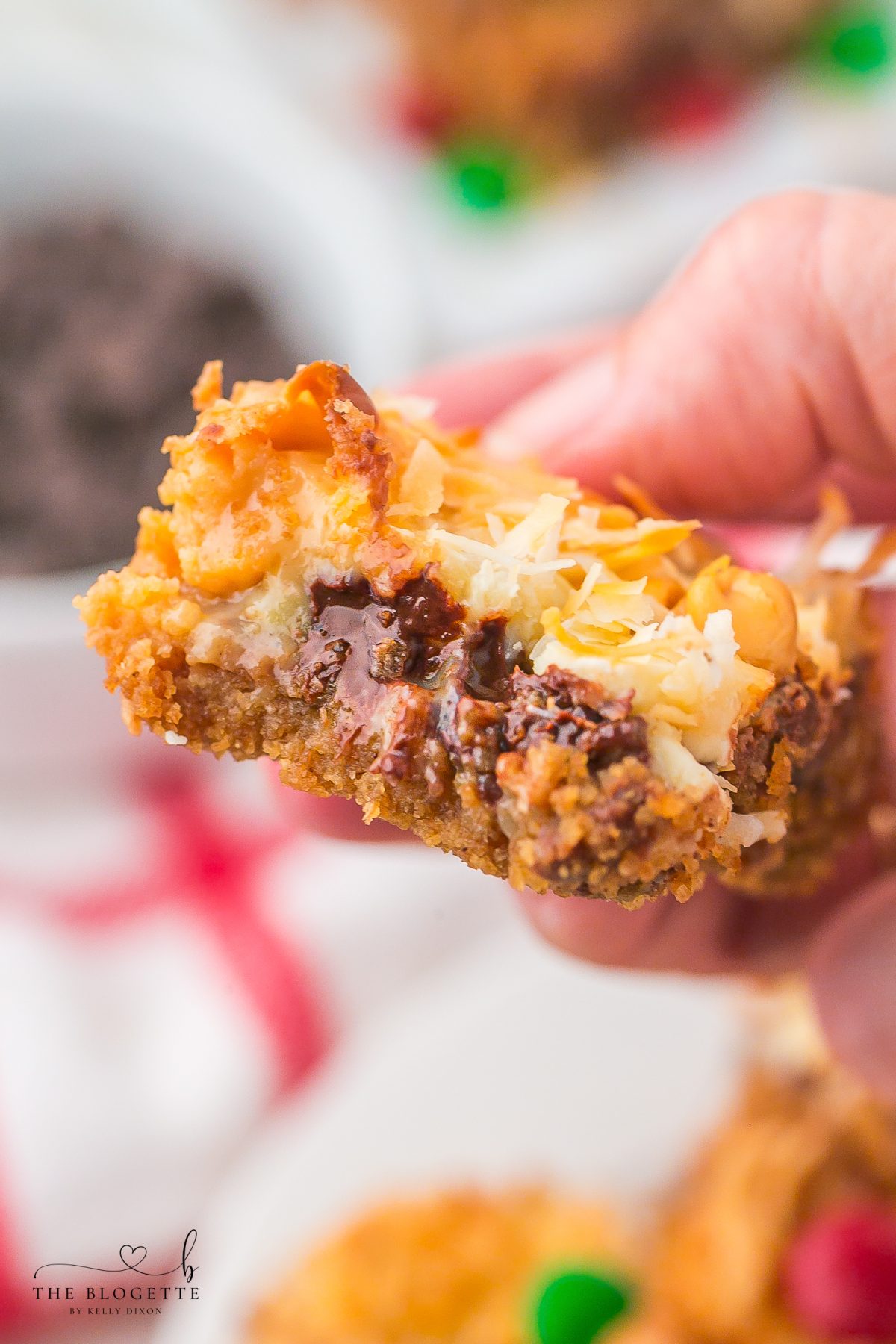 Easy Christmas Magic Bars made with graham crackers, sweetened condensed milk, chocolate chips, coconut, and festive M&M’s. A quick holiday dessert everyone loves!