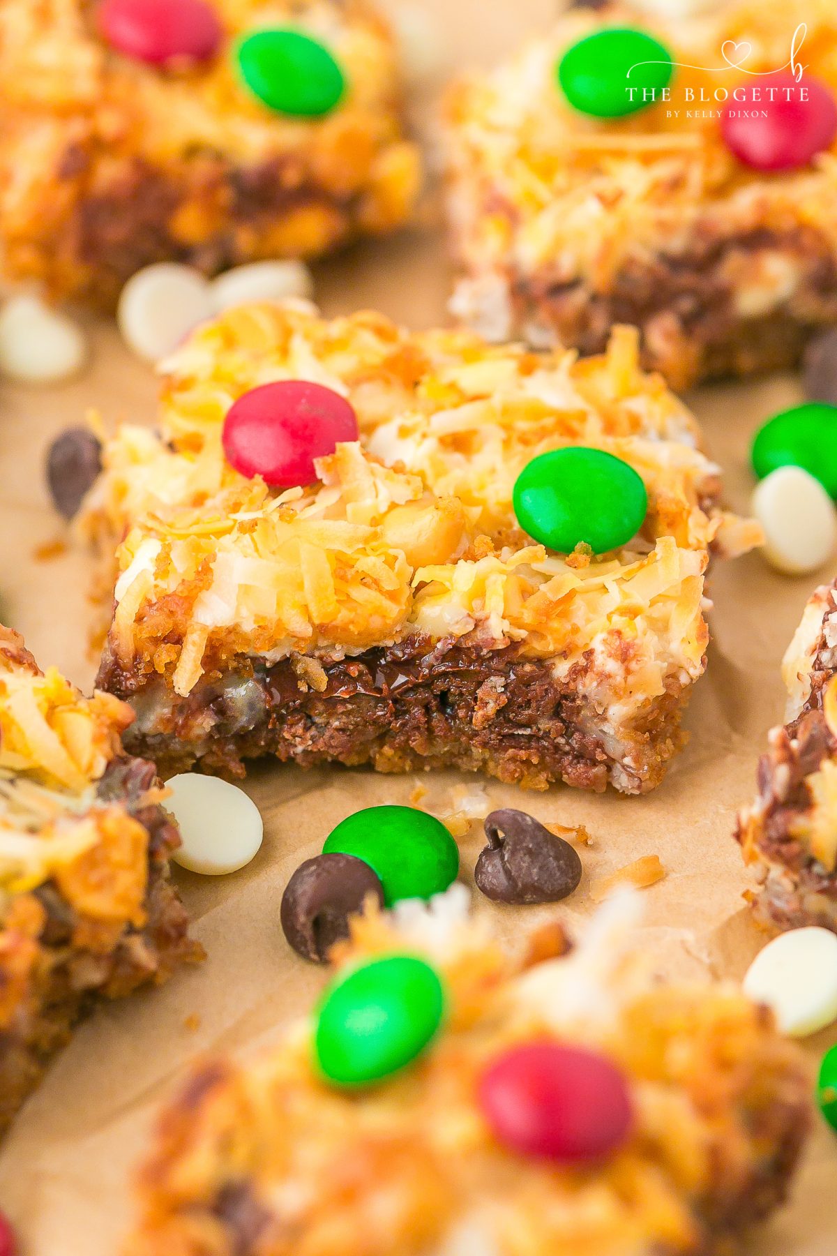 Easy Christmas Magic Bars made with graham crackers, sweetened condensed milk, chocolate chips, coconut, and festive M&M’s. A quick holiday dessert everyone loves!