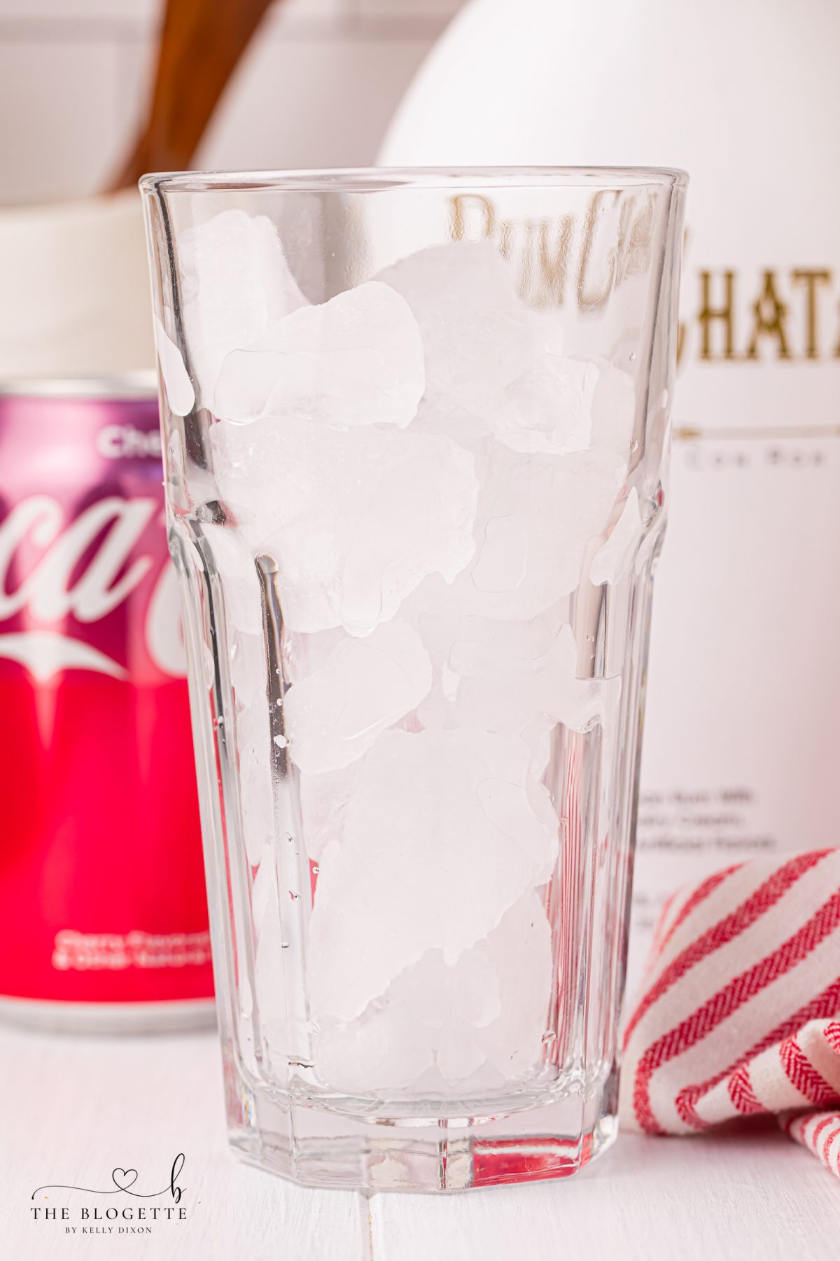 Fill a glass with ice.