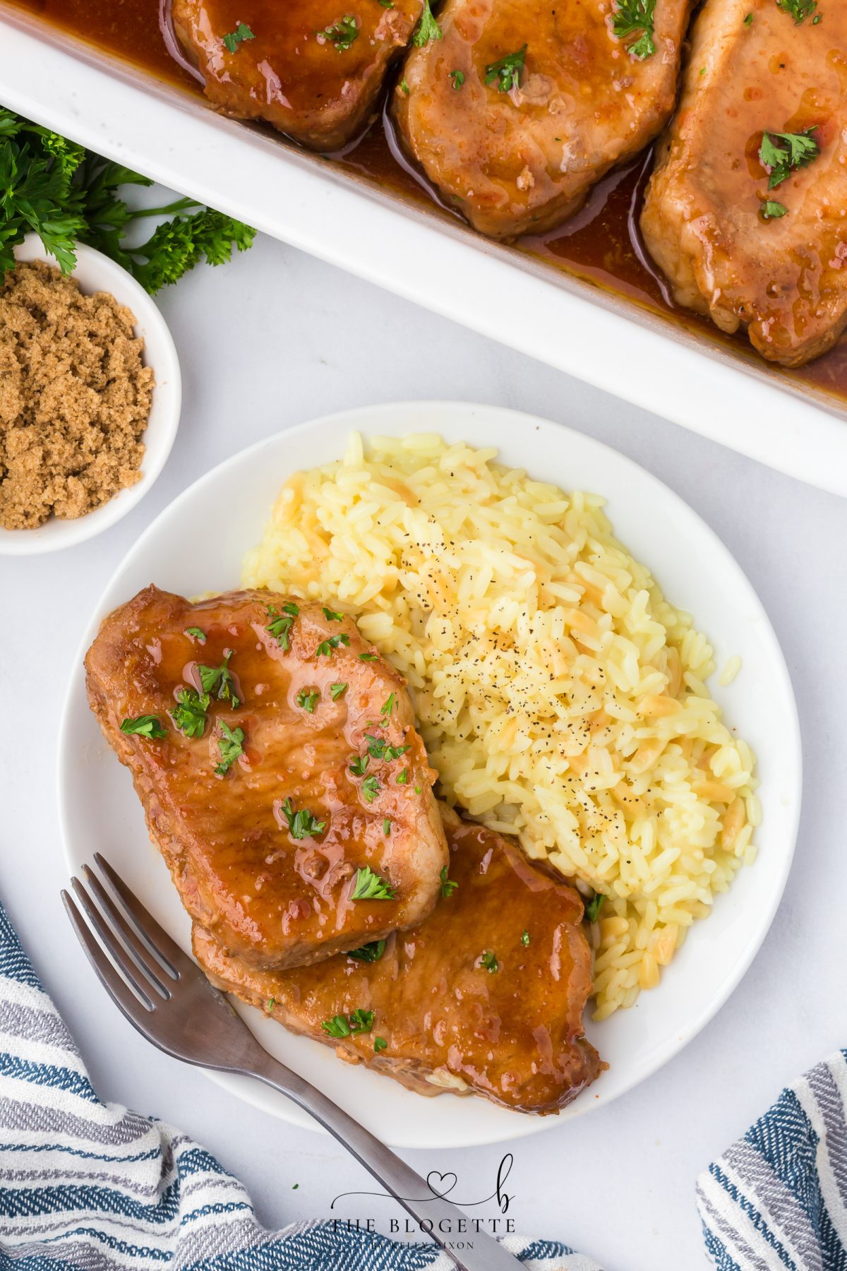 These Brown Sugar Pork Chops are coated in a rich, buttery, sweet-and-savory glaze that bakes into juicy perfection. Easy weeknight recipe with oven and crock pot options! Save this family-favorite pork chop idea for dinner tonight.
