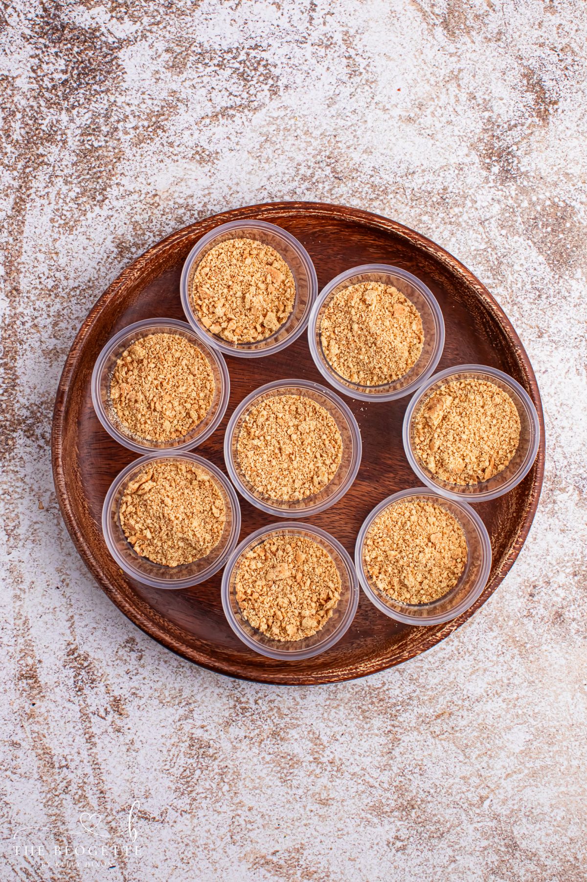 Spoon graham cracker crumbs into the bottoms