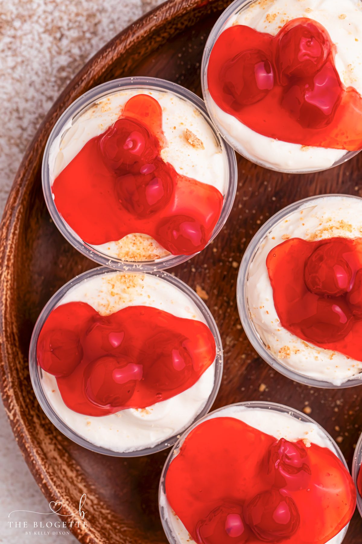 Cherry Cheesecake Shots 🍒✨ The perfect no-bake party dessert! Made with cheesecake pudding, Cool Whip, RumChata, graham crackers, and cherry pie filling. Easy dessert shooters for holidays, girls’ night, brunch, and celebrations. Try this simple make-ahead dessert idea!